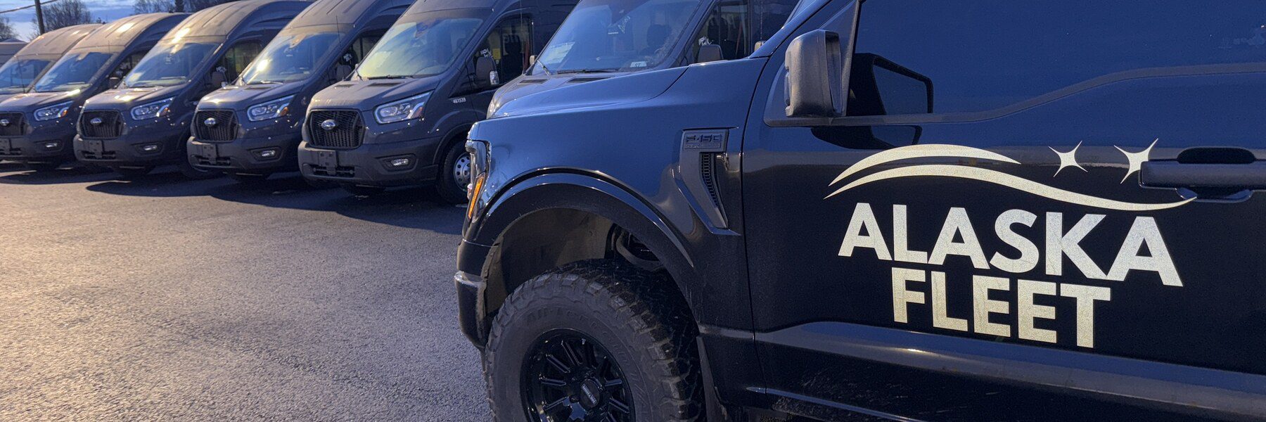 Alaska Fleet branded pickup in front of a row of fleet vans