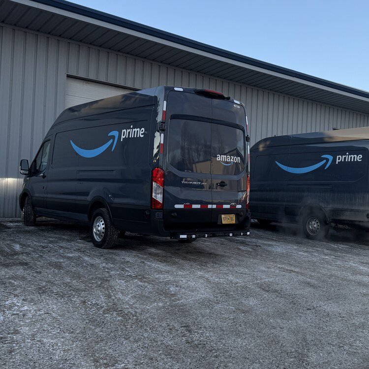 Fleet delivery vans parked outside the shop